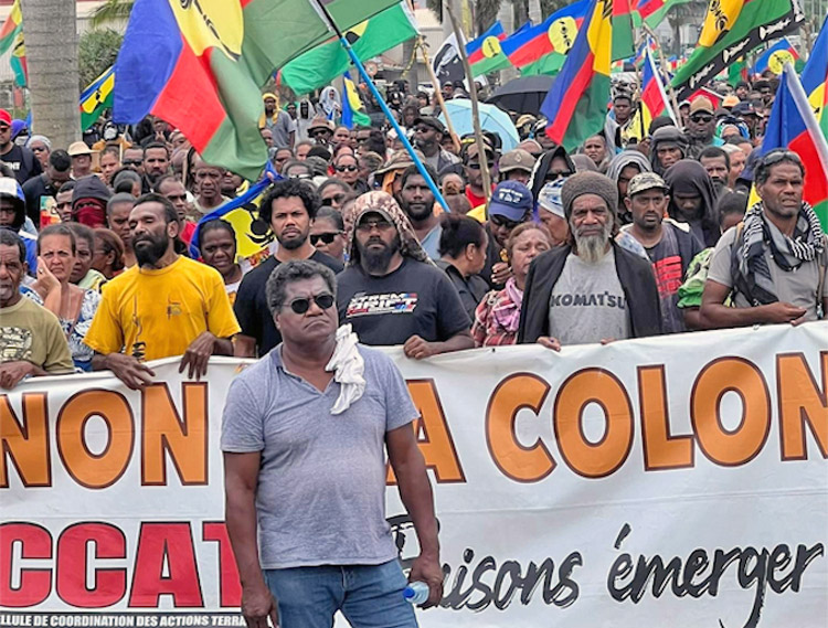 Thousands of Kanak protesters march behind banner, “No to colonialism,” in Noumea, New Caledonia, March 27. After actions paralyzed capital May 13, Paris sent in extra troops, police.