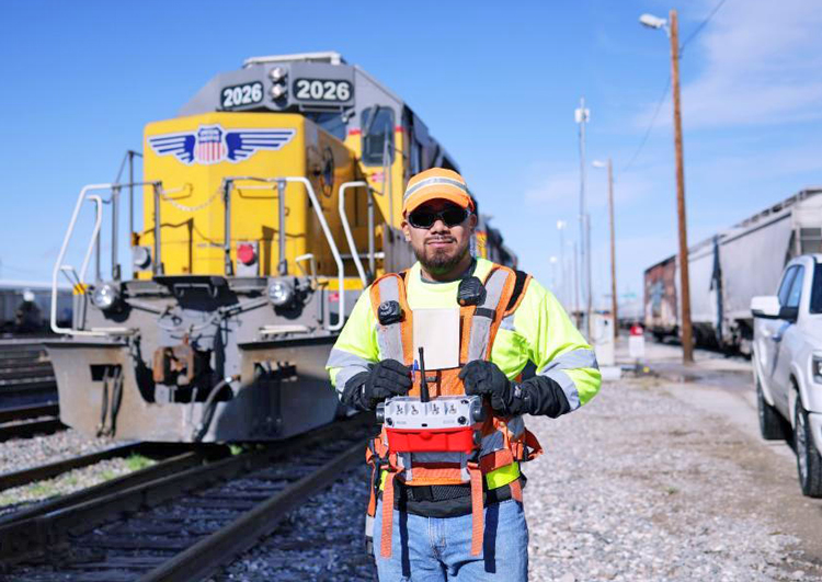 Rail worker runs driverless train with remote control in San Antonio, Texas, in 2023. Expansion of remote control operation beyond rail yards is product of bosses’ drive for profits. It’s led to more injuries, deaths of rail workers and working people who live near train tracks.