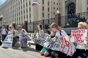Wives, mothers and children of Russian soldiers drafted in 2022 mobilization picket Defense Ministry in Moscow June 3. Placard on right says, “It’s time for the mobilized to come home.”