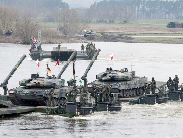 Nine NATO powers, from U.S. and Europe, engage in joint military exercise in Poland, involving 20,000 troops with tanks and other armored vehicles, including crossing of Vistula River, above, March 4. Operation Dragon 24 was designed as a test response to attack by Moscow.
