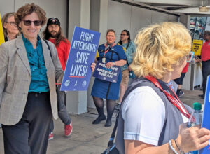 Rachele Fruit, left, SWP candidate for president, joined flight attendants’ picket line at Cleveland Hopkins airport June 13. Workers demand wage increases, pay for all hours worked.