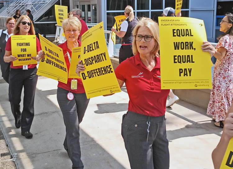 Flight attendants at Endeavor Air, a subsidiary of Delta Air Lines, rally at Minneapolis-St. Paul airport July 31 demanding parity in wages, benefits, scheduling with Delta flight attendants.