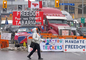 Truckers protest in Ottawa, Canada’s capital, Feb. 8, 2022, calling for an end to government pandemic restrictions threatening their livelihoods. Trudeau government put Freedom Convoy leaders on trial despite court ruling its use of the anti-labor Emergencies Act was illegal.