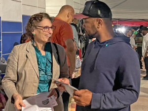 Obrero portuario Louie McKinnon habla con Rachele Fruit, candidata presidencial del PST, en Miami, agosto 11. “Ni demócratas, ni republicanos están interesados en los trabajadores”, dijo.