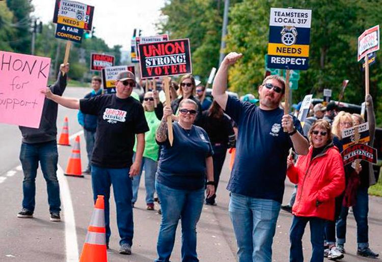 Picket by BorgWarner workers as first strike in 30 years began Sept. 9 at auto parts plant in Lansing, New York. Over 700 Teamster unionists are fighting for better wages, health care.