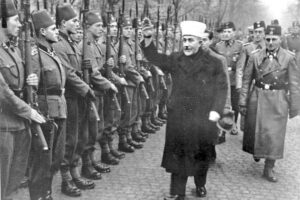 Hamas forerunner, Amin al-Husseini, salutes Waffen SS troops in Bosnia, 1943. “Hamas has a Nazi-like program and record,” SWP presidential candidate Rachele Fruit told Atlanta meeting. 