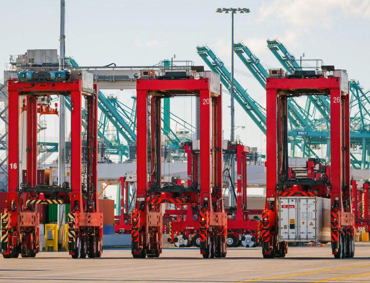 Automated straddle carriers have replaced drivers on Los Angeles docks. Bosses seek automation to boost output, profits by eliminating jobs. With working class in power, benefits of technology would flow broadly to working people, with jobs, pay and safety protected.