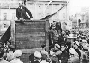 V.I. Lenin, leader of Bolshevik Party that led Russian workers, peasants in world’s first socialist revolution, speaks in Moscow in May 1920. Standing next to podium is Leon Trotsky. Pathfinder distributes works by Lenin, Trotsky, Fidel Castro, Malcolm X, Evelyn Reed and many others.