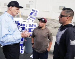 Dennis Richter, left, SWP candidate for vice president, and campaign supporter Gabriel Calderon, a bakery worker, center, join UAW strike picket line at Monogram Aerospace Oct. 10.