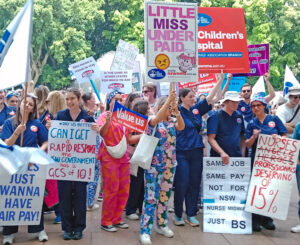 More than 10,000 nurses and midwives march outside New South Wales state Parliament in Sydney, Australia, Sept. 24, part of one-day strike for an immediate 15% wage raise.