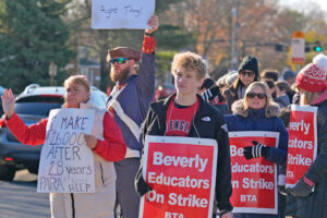 Striking teachers, supporters picket Nov. 22 in Beverly, Massachusetts, over pay, especially for paraprofessionals. Two-week-long strikes ended with tentative agreements reached Nov. 26.