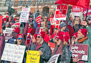 Striking teachers from Beverly, Gloucester and Marblehead rallied at Massachusetts Statehouse in Boston Nov. 19, part of fight for parental leave, hiring and increased pay for teachers’ aides.