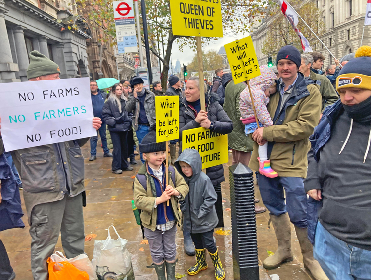 Thousands of farmers, their families and supporters from across U.K. rally in London Nov. 19 against government imposition of new farm taxes. Farmers face rising costs, lower income.