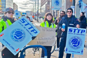 Striking members of Canadian Union of Postal Workers picket at Chabanel Street depot in Montreal Nov. 25. Homemade sign says, “Heroes in pandemic. Zeros now! Thanks!”