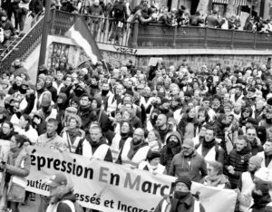 President Emmanuel Macron is driving to solve capitalist crisis in France on the backs of working people. Above, massive “yellow vests” 2019 protest against Macron’s policies held in Paris.