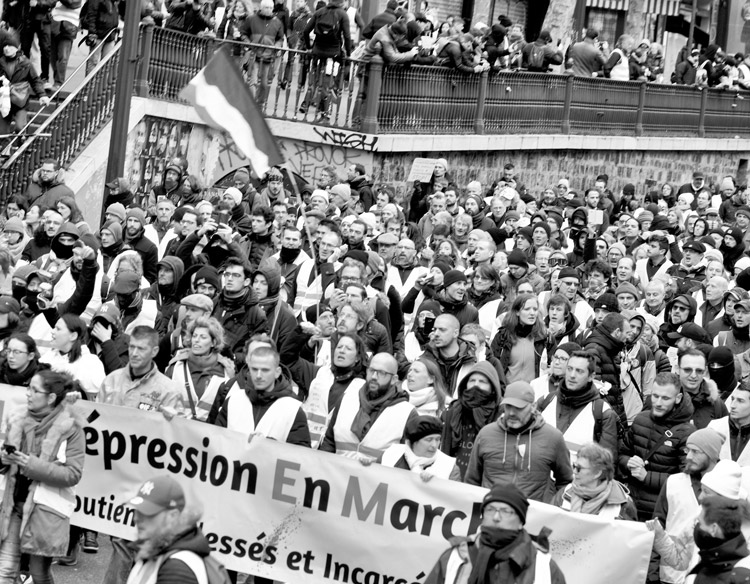 President Emmanuel Macron is driving to solve capitalist crisis in France on the backs of working people. Above, massive “yellow vests” 2019 protest against Macron’s policies held in Paris.