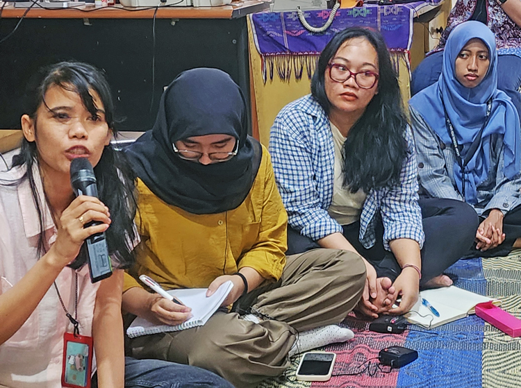 Organizations representing women workers met Nov. 11 at the offices of Kalyanamitra, a women’s rights organization. Speaking at left is Ika Agustina, the group’s executive director.