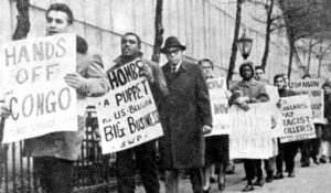 “Hands off Congo” picket at U.N. December 1964, called by Socialist Workers Party and Young Socialist Alliance, protesting intervention in Congo by rulers of the U.S. and Belgium. In front, Richard Garza, Socialist Workers Party candidate for U.S. Senate; third is Clifton DeBerry, SWP 1964 candidate for president. Inset, Malcolm X speaking at a rally in Harlem, June 23, 1963.