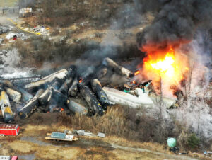 Uncontrolled toxic fire from 2023 Norfolk Southern derailment in East Palestine, Ohio. Rail workers, area residents are still fighting for justice and to prevent future disasters.