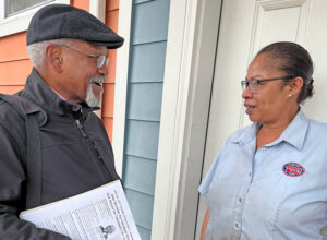 John Hawkins, Socialist Workers Party candidate for mayor of Cincinnati, talks with Dawn WiIley in Lincoln Heights. “You are explaining things that need to be heard,” Willey said.