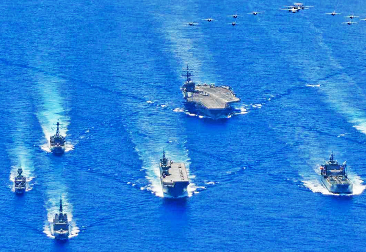 Joint war games by U.S., Japanese, Australian military forces in the Philippine Sea in 2020. U.S. rulers look to defend their military, financial supremacy from expanding reach of Beijing.