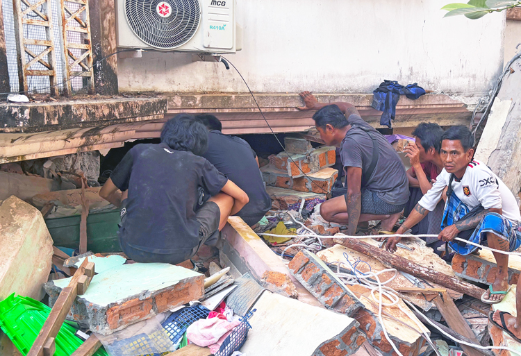 Volunteers search for survivors in Nay Pyi Taw, Myanmar, March 28. Thousands tried to save people using only their hands after gov’t officials refused to provide tools or equipment.