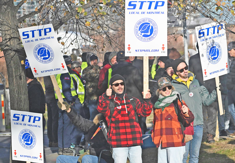 Canada Post workers picket outside sorting plant in Montreal, Nov. 15, 2024. Government ordered them back to work after four weeks, as it had done to striking rail and port workers.