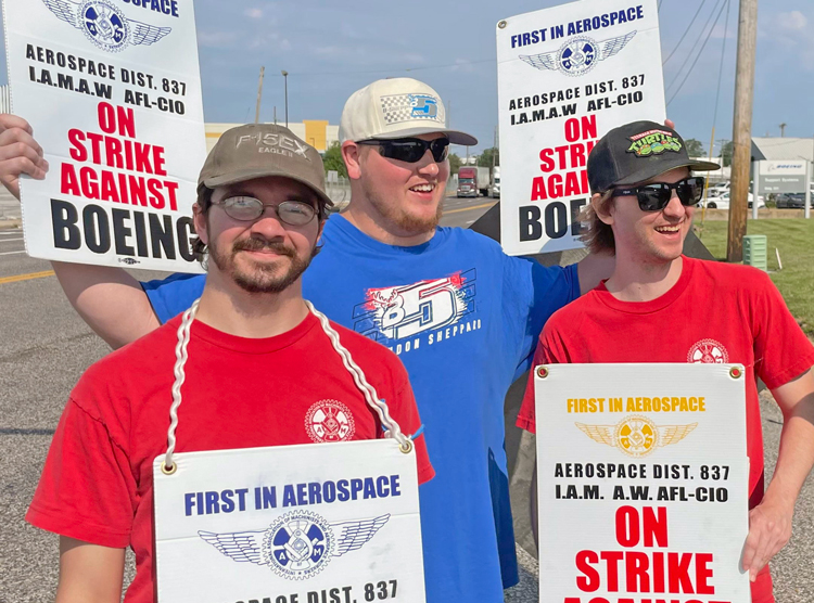 IAM Local 837 members on strike against Boeing join picket line in St. Louis Aug. 7. In center is Zac Boeger, Clyde Miller at right. They’re fighting for a pay raise for all, end to big wage gap.
