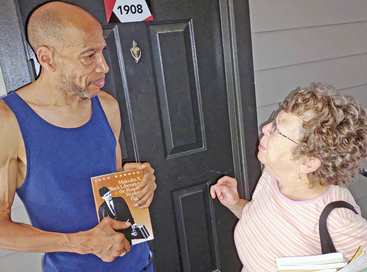 Susan LaMont, SWP candidate for Atlanta mayor, talks with retired construction worker Curtis Harris in Union City, Georgia, Aug. 2. He subscribed to the <i>Militant,</i> got book in his hand.
