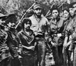 Revolutionary leader Fidel Castro with members of the Mariana Grajales Women’s Platoon of the Rebel Army in 1958. He is between Teté Puebla, left, and commander Isabel Rielo. Socialist revolution drew women, workers, blacks and peasants to transform themselves and Cuba.