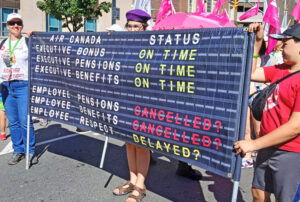 Banner at Labor Day parade in Toronto Sept. 1 explained class reality facing Air Canada flight attendants. Their Aug. 16-19 strike continued in defiance of a federal government back-to-work order. This is the fourth strike in past year where Ottawa intervened on side of the bosses.