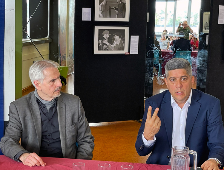 Luis Morejón Rodríguez, Cuba’s ambassador to New Zealand, right, and author Robert Bartholomew at program in Auckland Nov. 23. “Cuba, other countries of Latin America, face real challenges as U.S. government moves to take military action in Venezuela,” Morejón said.