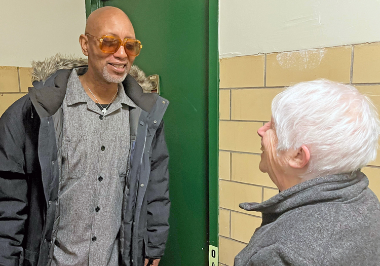 SWP campaigner Beverly Bernardo with Tyrone Morgan, Militant subscriber, retired member of AFSCME Local 372, in New York Dec. 7. “I love everything about the paper, it tells the truth about what’s really happening in the world,” he said. Morgan bought a book, gave $3 donation.