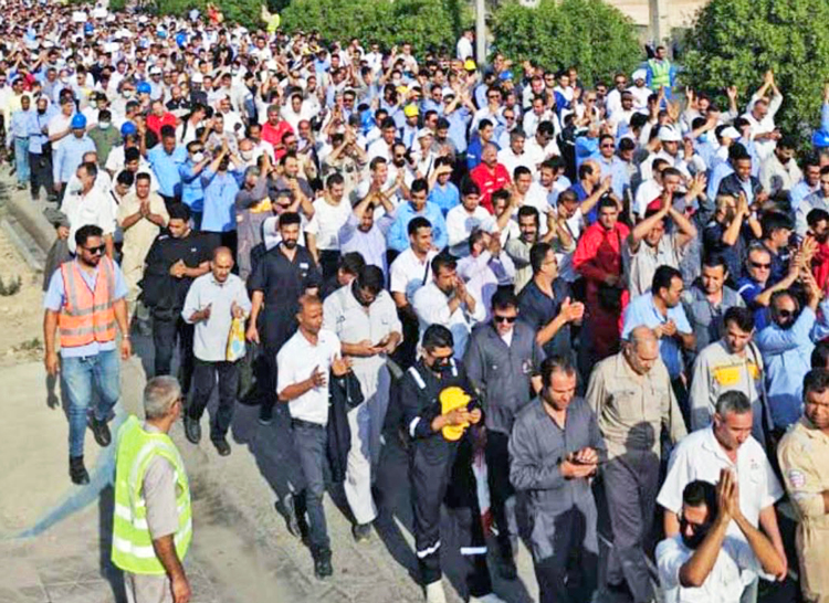 Thousands of oil and gas workers march in Asaluyeh in southern Iran Dec. 9 for higher wages, job safety and better conditions for contract workers, one of largest labor actions in decades.