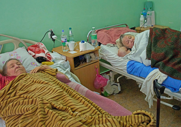 Nataliia Naumova, 70, right, recovers from FPV drone attack in Kherson hospital, Ukraine, Nov. 3. Russian drone operators conduct “human safaris” on Ukrainian civilians in Kherson.