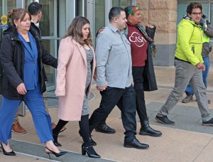 Kilmar Ábrego García, center, outside U.S. District Court hearing in Greenbelt, Maryland, Dec. 22 along with, from left, his mother, Cecilia, and wife Jennifer Vasquez Sura. Inset, more than 100 supporters rallied there in his defense, some carrying signs from SMART, his union.