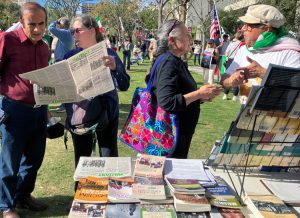 Socialist Workers Party members Deborah Liatos, left, and Ellie Garcia, center, campaign with Militant, books by party leaders at Jan. 18 Los Angeles rally. Thousands came out in solidarity with mass demonstrations in Iran protesting the reactionary government in Tehran.
