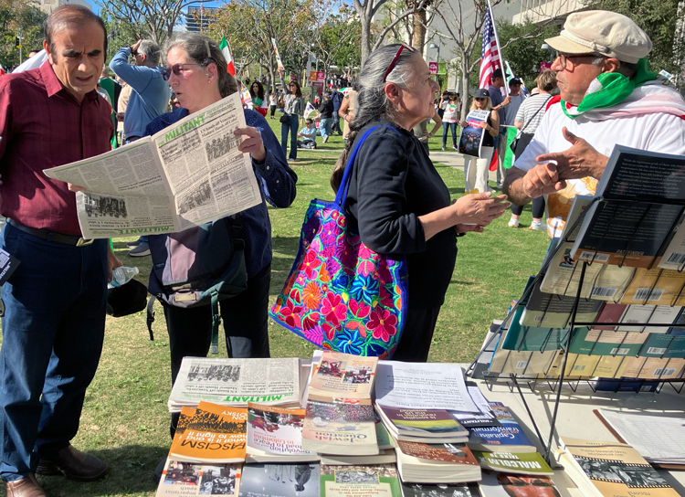 Socialist Workers Party members Deborah Liatos, left, and Ellie Garcia, center, campaign with Militant, books by party leaders at Jan. 18 Los Angeles rally. Thousands came out in solidarity with mass demonstrations in Iran protesting the reactionary government in Tehran.