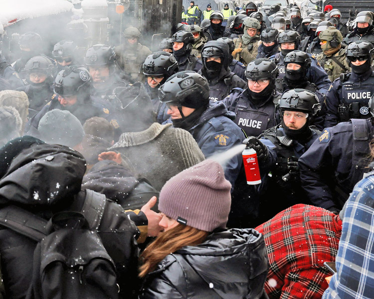 Police use pepper spray as they assault truckers and other protesters in Ottawa Feb. 19, 2022. Federal government used the Emergencies Act to attack free speech, right to protest.