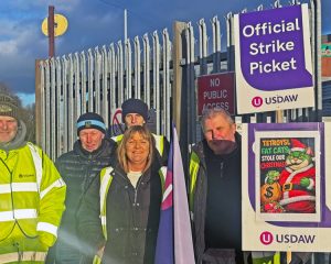 Warehouse and distribution workers in Rochdale, England, picket against wage cuts Jan. 2 at Tetrosyl, Europe’s largest manufacturer of car care products. They also seek union recognition.