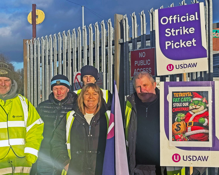 Warehouse and distribution workers in Rochdale, England, picket against wage cuts Jan. 2 at Tetrosyl, Europe’s largest manufacturer of car care products. They also seek union recognition.