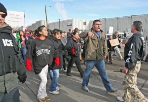 Greeley, Colorado, JBS plant employs majority immigrant workers, with over 1,000 from Haiti. In 2006, above, raid by ICE agents was met there by relatives, supporters defending the workers.