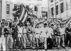Cubans have long, proud history of fighting Washington’s interventions. Above, protest against U.S.-backed coup by Fulgencio Batista, April 6, 1952. Raúl Castro is waving flag.