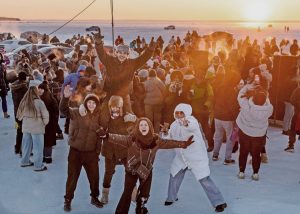 People dance at sunset on frozen Kyiv Sea reservoir on Dnipro River in Ukraine Feb. 1. Working people refuse to be intimidated despite Moscow’s airstrikes on country’s electrical infrastructure causing widespread power and heating outages in middle of the winter.