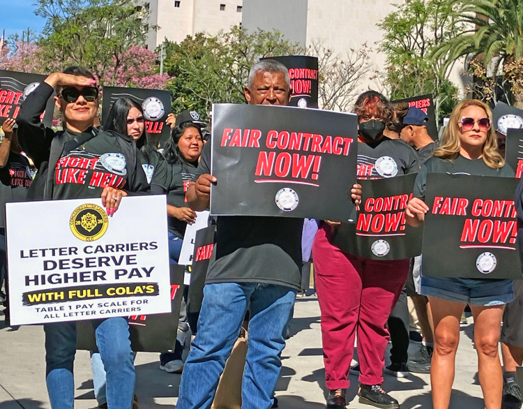 Members of National Association of Letter Carriers rally by City Hall in Los Angeles Feb. 22, part of national day of action in fight for contract with better pay, working conditions, respect.