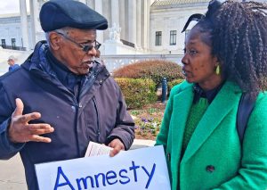 “I like that sign for amnesty,” Medelinda Charles, a Haitian law student, told James Harris, SWP candidate from Washington, D.C. She bought a Militant subscription to learn more.