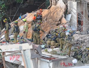 Search team at residential building in Haifa hit by Iranian missile April 6. Missiles launched by Tehran targeting civilians have killed or wounded both Jewish and Arab citizens of Israel.