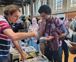 Interest in Pathfinder books was high at the Paris African Bookfair March 21-22, reflected in sale of 174 books, including 31 copies of Cuba and the Independence War in Guinea-Bissau and Cape Verde. Pathfinder volunteer Arnold Lesort-Pajot, above left, introduces books, Militant.