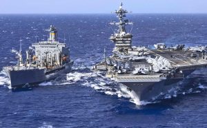 USS Abraham Lincoln, above right, leads one of three U.S. carrier strike groups in Middle East as Washington blockades boats from Iran’s ports, threatens escalation, seeks new negotiations.