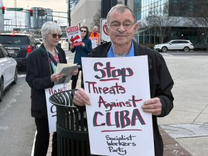 John Benson protests U.S. blockade, growing threats against Cuba in Atlanta Feb. 17. He was won to support the Cuban Revolution as a student at Carleton College over 60 years ago.